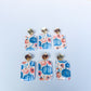 Set of floral and pumpkin patterned earrings on a blue and orange background